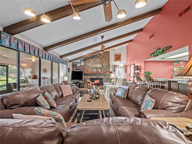 living room featuring ceiling fan, a textured ceiling, vaulted ceiling with beams, a fireplace, and visible vents