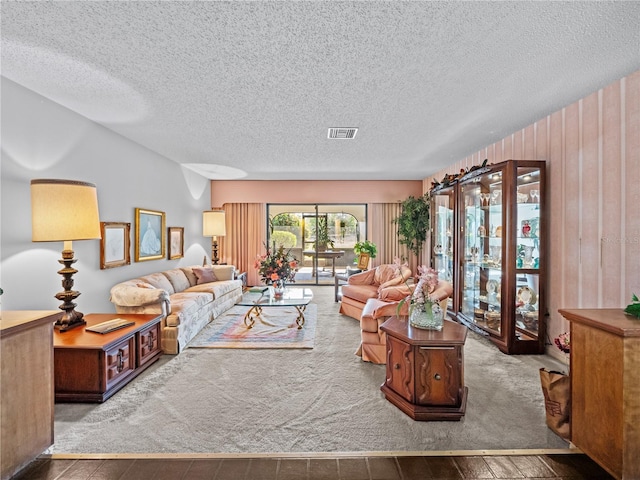 living room with visible vents and a textured ceiling