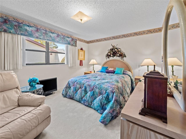 bedroom featuring carpet floors and a textured ceiling