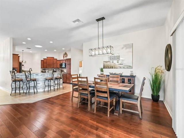 dining room featuring recessed lighting, baseboards, visible vents, and hardwood / wood-style floors