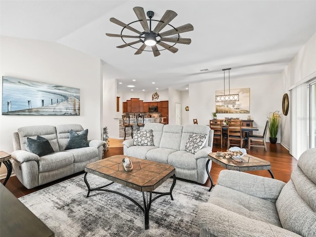 living area with a ceiling fan, recessed lighting, vaulted ceiling, and wood finished floors