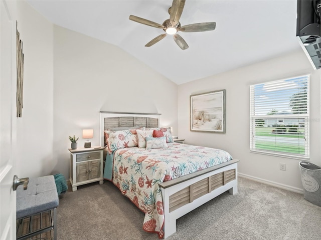 carpeted bedroom with vaulted ceiling, a ceiling fan, and baseboards