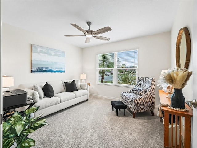 carpeted living room featuring ceiling fan and baseboards