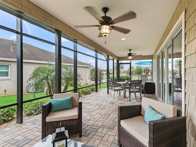 sunroom with a ceiling fan