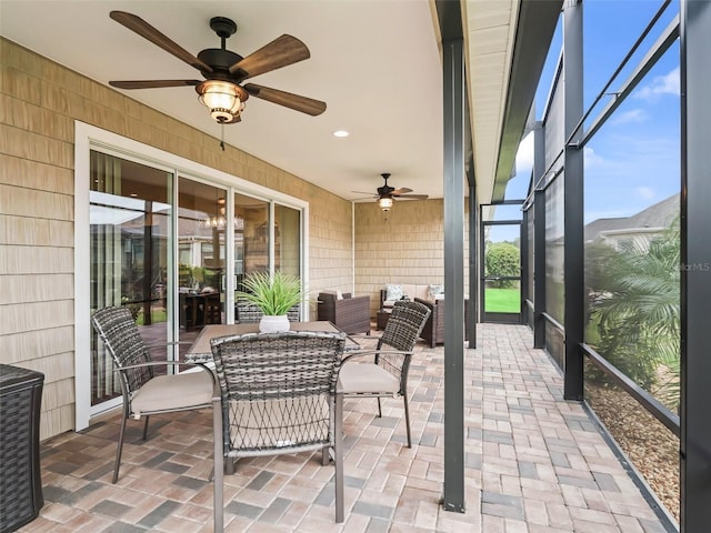 sunroom featuring ceiling fan