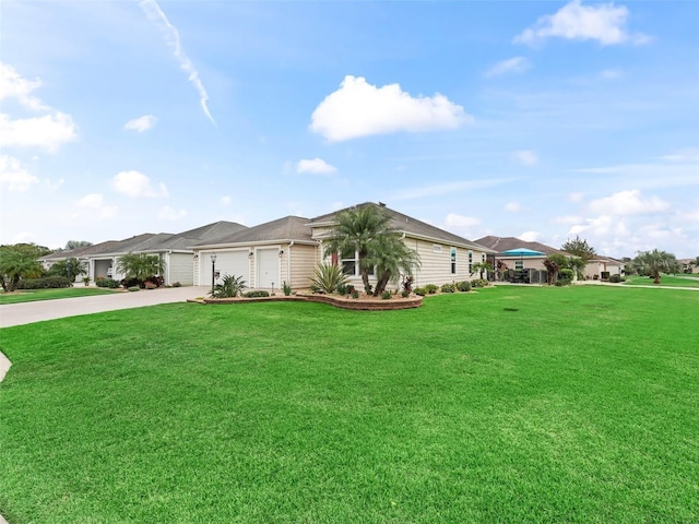 ranch-style home featuring a garage, driveway, and a front lawn