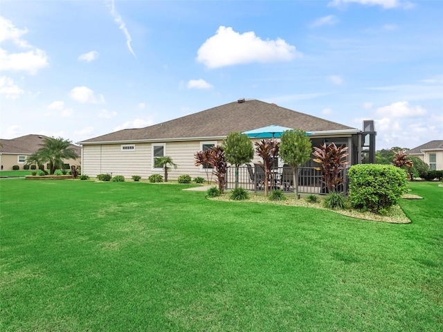 back of house featuring a yard