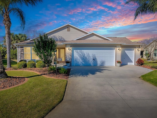 ranch-style house with an attached garage, a lawn, and concrete driveway