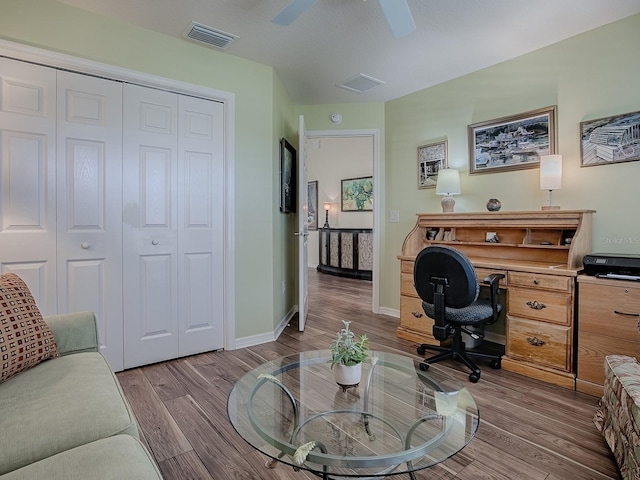 office with visible vents, baseboards, and wood finished floors