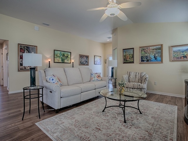 living area with ceiling fan, lofted ceiling, visible vents, baseboards, and dark wood-style floors