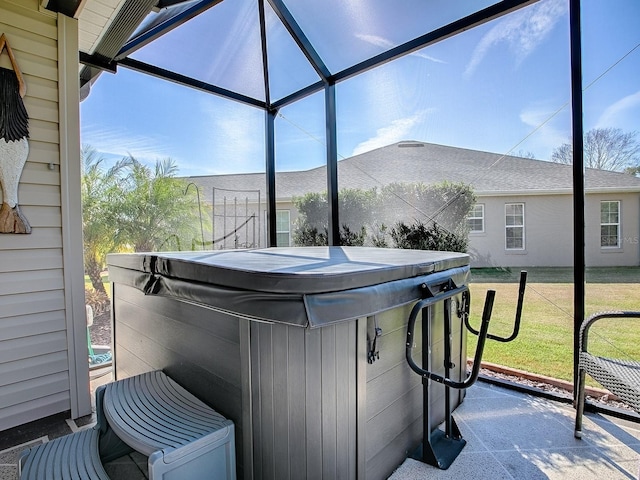 view of patio with a lanai and a hot tub