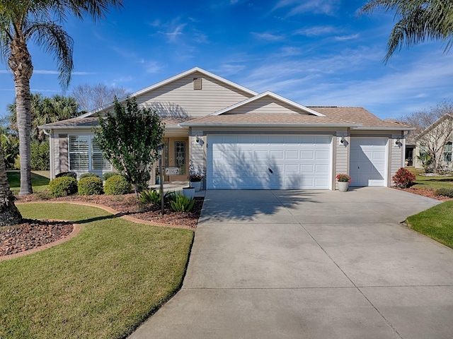 ranch-style house with an attached garage, driveway, and a front lawn