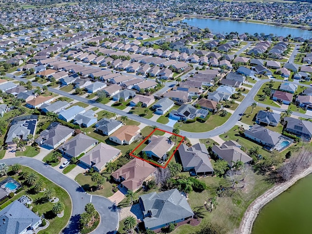 birds eye view of property with a water view and a residential view