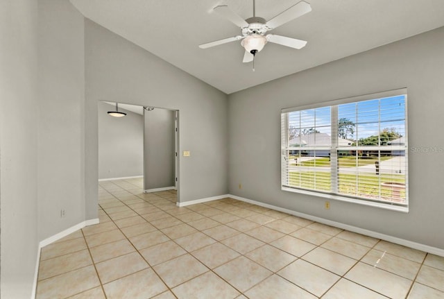 unfurnished room with light tile patterned floors, ceiling fan, lofted ceiling, and baseboards