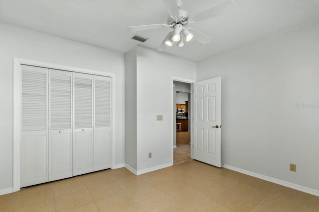 unfurnished bedroom with a ceiling fan, a closet, visible vents, and baseboards