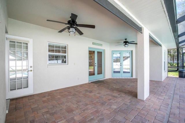 view of patio / terrace featuring ceiling fan, french doors, and a lanai