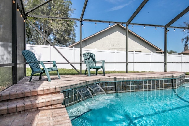 view of swimming pool featuring a patio area, a fenced backyard, glass enclosure, and a fenced in pool