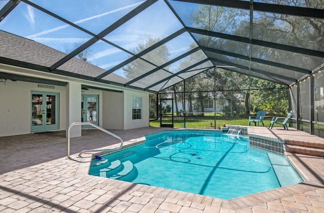 outdoor pool featuring a patio, french doors, and glass enclosure