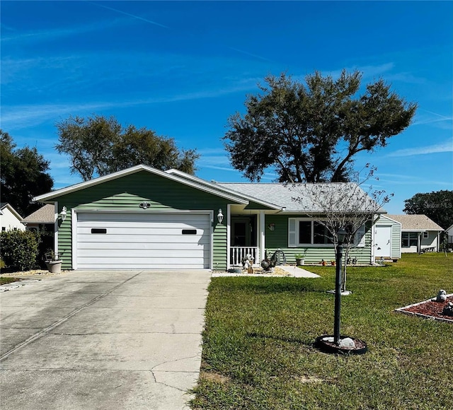 ranch-style home with an attached garage, concrete driveway, and a front yard