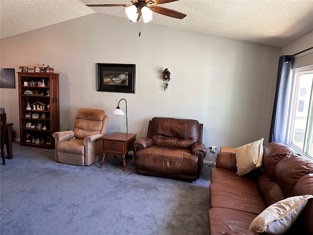 living area featuring lofted ceiling, ceiling fan, a textured ceiling, and carpet flooring