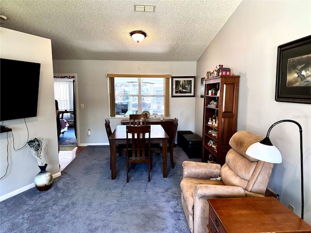 carpeted dining area featuring visible vents, a textured ceiling, and baseboards