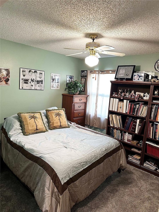 bedroom featuring a textured ceiling, carpet, and a ceiling fan