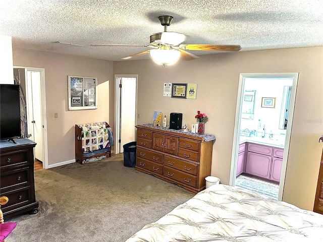 carpeted bedroom featuring a textured ceiling, a ceiling fan, and ensuite bathroom