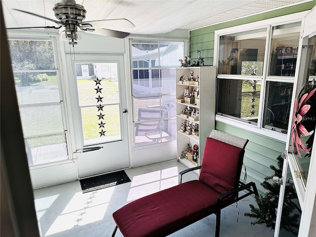 sunroom featuring a ceiling fan