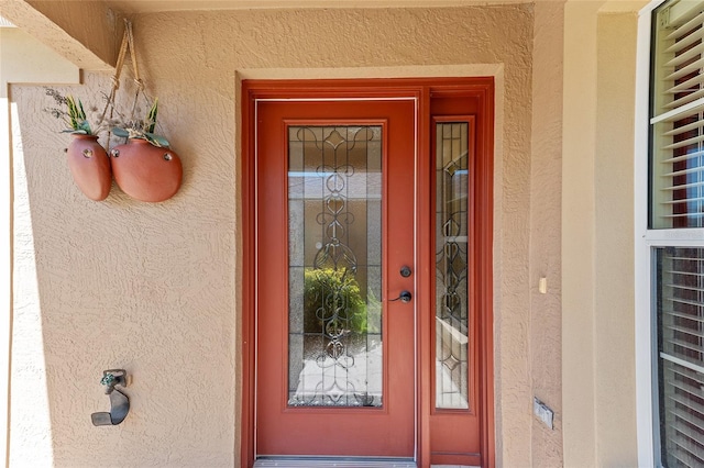 property entrance featuring stucco siding