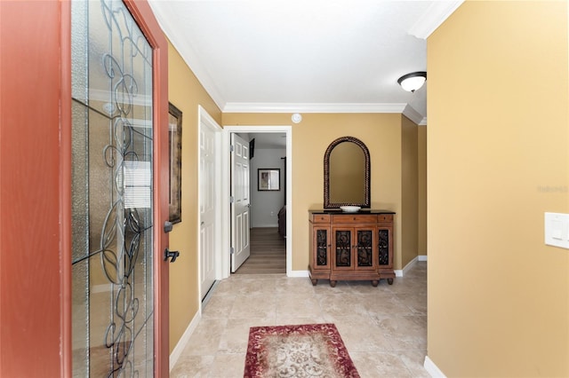 interior space featuring tile patterned flooring, crown molding, and baseboards