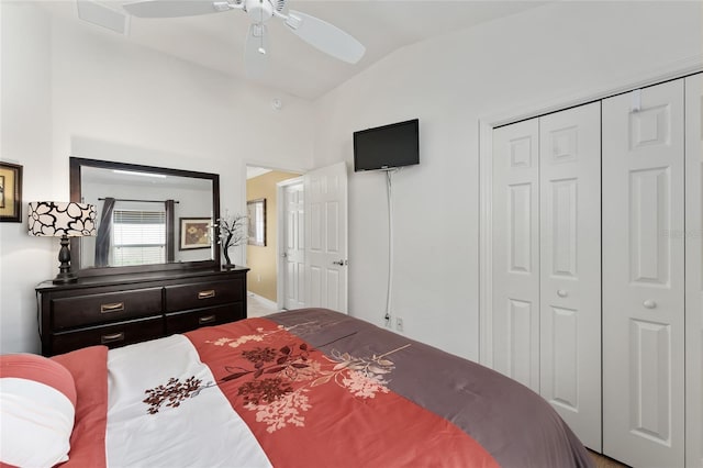 bedroom featuring a ceiling fan, a closet, visible vents, and vaulted ceiling