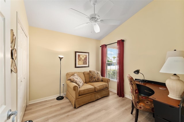 home office featuring ceiling fan, vaulted ceiling, light wood-style flooring, and baseboards