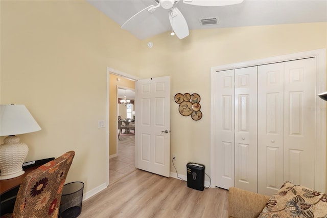 bedroom featuring a closet, visible vents, light wood-style flooring, vaulted ceiling, and baseboards