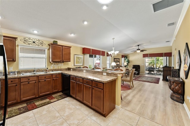 kitchen with dishwasher, a peninsula, a sink, and visible vents