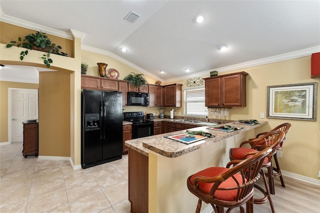 kitchen with lofted ceiling, visible vents, ornamental molding, a peninsula, and black appliances