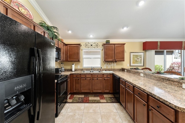 kitchen with light tile patterned floors, ornamental molding, a peninsula, black appliances, and a sink