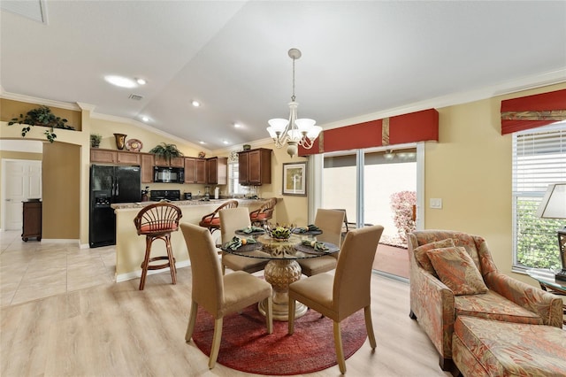 dining space with lofted ceiling, crown molding, visible vents, light wood finished floors, and an inviting chandelier