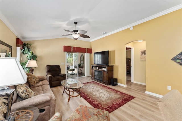 living room featuring arched walkways, light wood-style flooring, visible vents, and crown molding