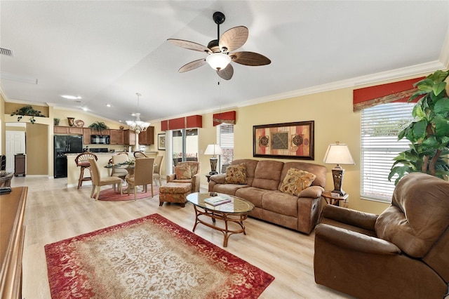 living room with light wood-type flooring, plenty of natural light, visible vents, and crown molding