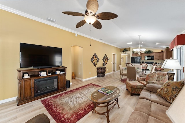 living area with light wood finished floors, lofted ceiling, visible vents, ornamental molding, and baseboards