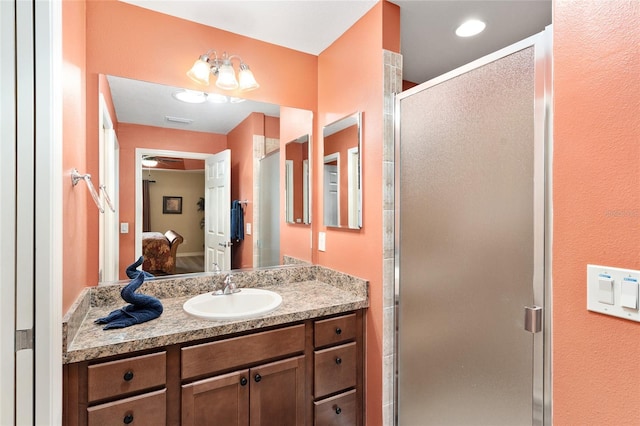 full bath with visible vents, connected bathroom, a shower stall, and vanity