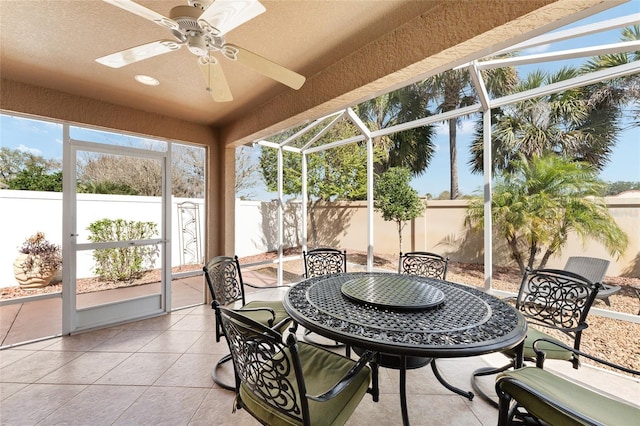 sunroom / solarium with a ceiling fan