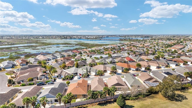 drone / aerial view featuring a water view and a residential view