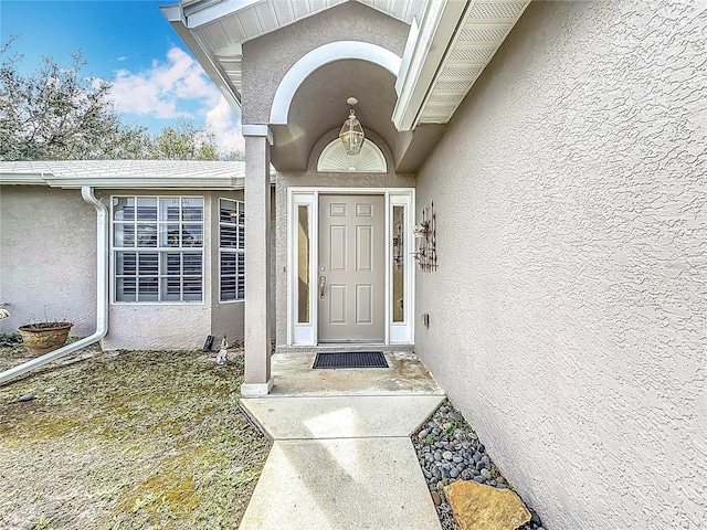 property entrance featuring stucco siding