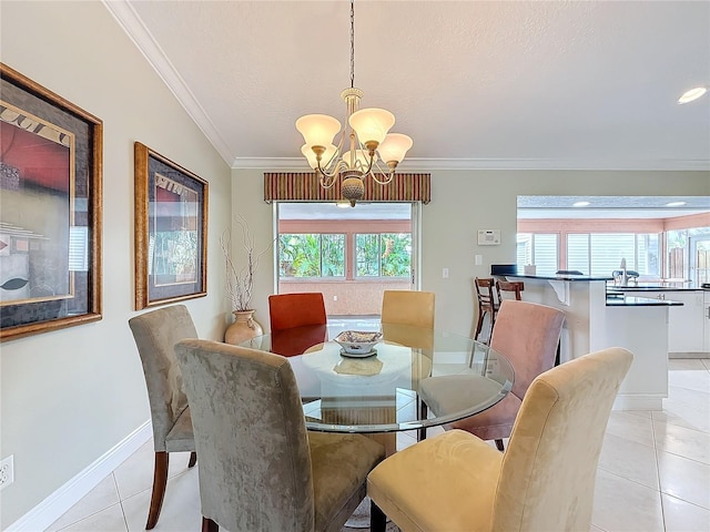 dining space with ornamental molding, baseboards, an inviting chandelier, and light tile patterned floors