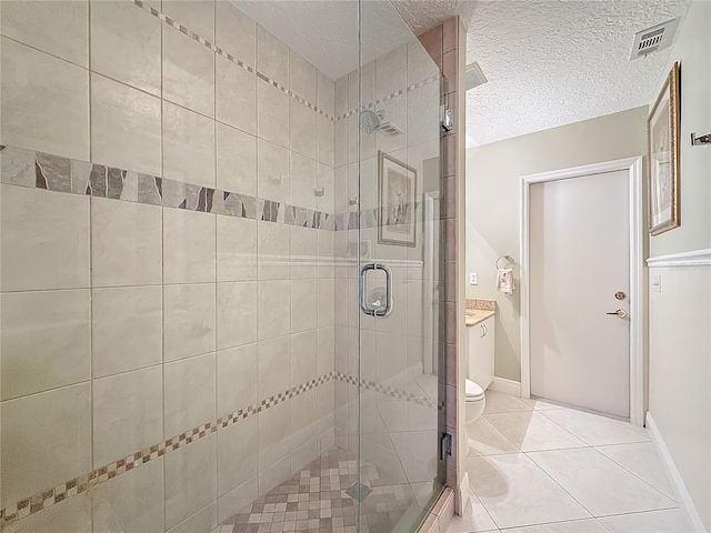 full bathroom with a textured ceiling, tile patterned flooring, toilet, visible vents, and a stall shower