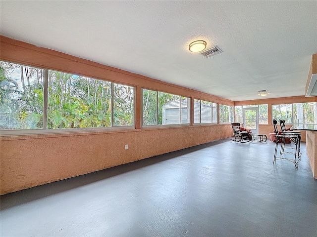 unfurnished sunroom with visible vents