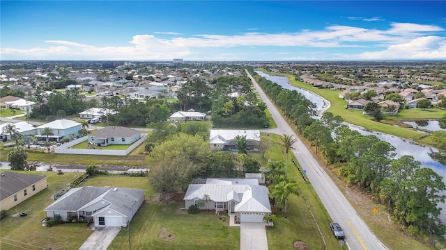 bird's eye view with a water view and a residential view