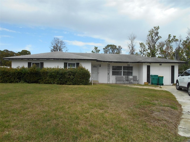 ranch-style home with an attached garage, driveway, and a front lawn