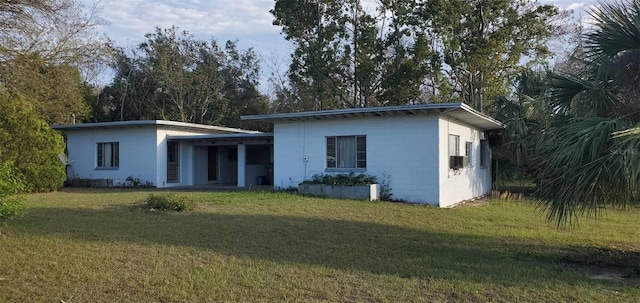 rear view of property with a yard